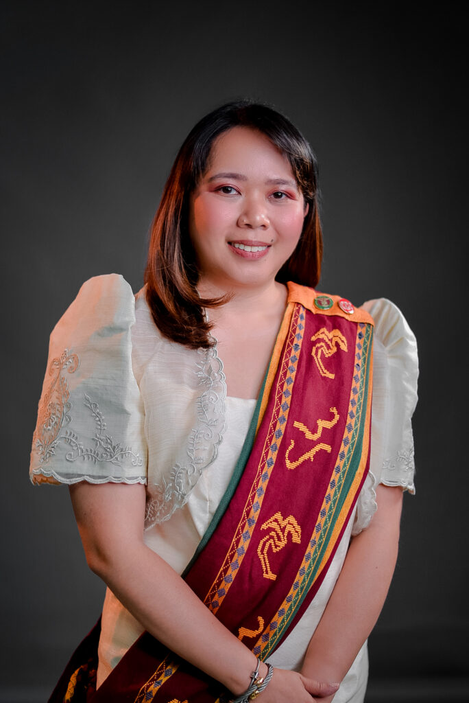 An image of Asst. Prof. Eleazar in formal wear wearing a Sablay.